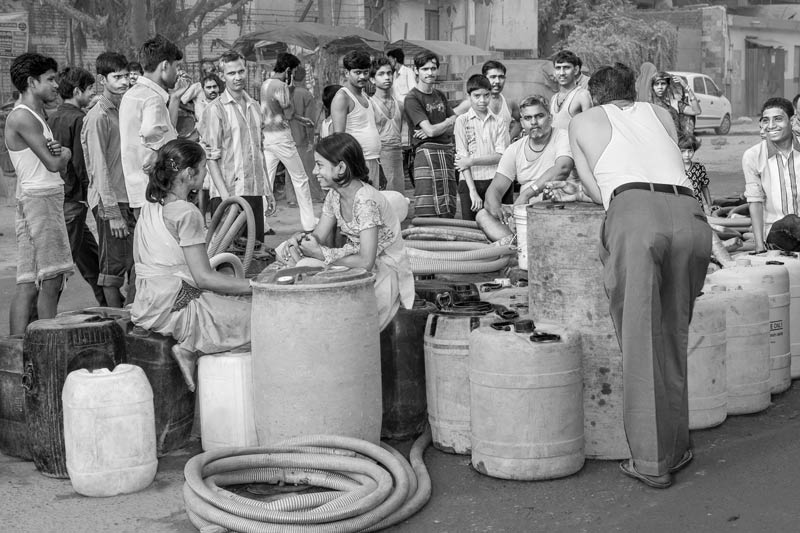 Human Right to Water in Delhi - Men and children in an unauthorized colony in Delhi anxiously awaiting arrival of the water tanker around 10 o'clock in the morning